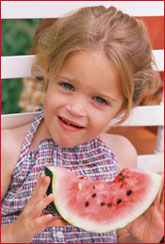 photo of girl eating watermelon